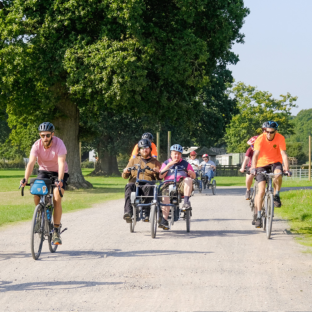 A collection of cyclists taking part in Pass the PEDALL 2024 at New Park in Brockenhurst